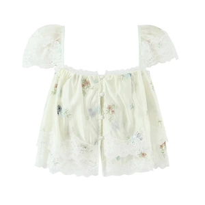 Detailed embroidery on vintage French lace crop top with floral stitching and ruffles