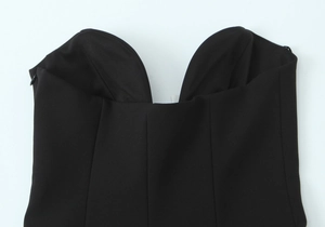 Detail of the sweetheart neckline and side zipper on a black structured strapless top