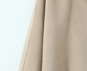 Detail shot of beige wool cashmere fabric texture with fine stitched edge craftsmanship