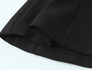 Detailed macro view of heavy scuba fabric texture and premium stitching on black top