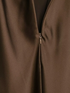 Detailed close-up of a seamless invisible zipper on a brown satin texture dress