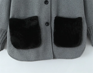 Detail of wool jacket with black faux fur pockets and knitted ribbed sleeve cuffs