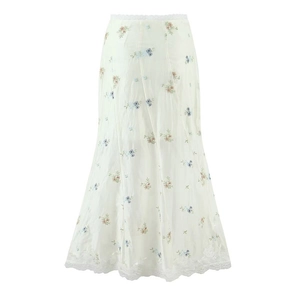 Detailed view of floral embroidery and lace trim on white high-waist midi skirt