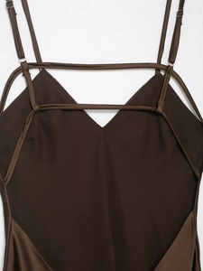 Detail of adjustable straps and silk satin fabric on a backless V-neck dress