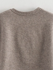 Close-up of the brown crew neck knit cardigan showing soft ribbed texture and fine details