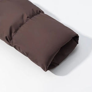 Detailed macro view of dark brown windproof sleeve cuff with quilted padded insulation
