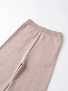 Close-up of beige knit pants featuring a comfortable high elastic waistband and soft texture