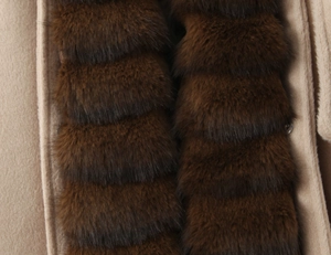 Detailed view of beige wool coat with luxurious dark brown faux fur trim accents