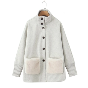Women's light grey wool coat with knit stand collar and cream faux fur pockets