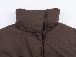Detail of high stand collar and black buttons on a dark brown winter padded coat