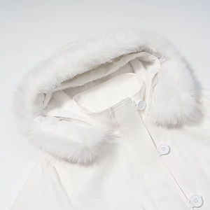 Close-up of white hooded jacket featuring high-density faux fur trim and snap buttons
