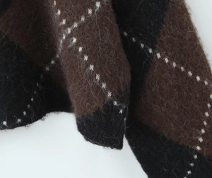 Macro view of plush brown and black plaid knit fabric with soft mohair texture