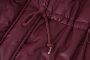 Detailed macro view of wine red quilted coat featuring adjustable drawstring waist details