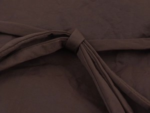 Detailed view of the dark brown fabric belt knot and durable stitching on the casual coat