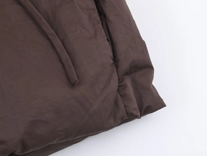 Close-up of chocolate brown parka drawstring detail with high-quality matte finish