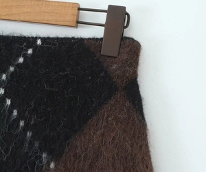 Detail of plush mohair knit skirt showing vintage brown and black checkered pattern