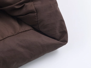 Detailed macro view of heavy-duty dark brown cotton fabric with textured weave and stitching