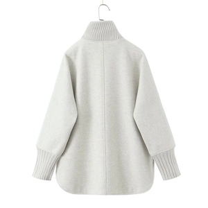 Detail view of oat gray women's coat with knitted collar and textured wool body