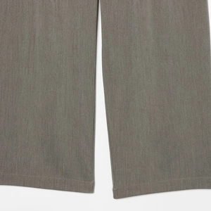 Close-up of grey melange straight leg trousers with detailed double-stitched hem and texture