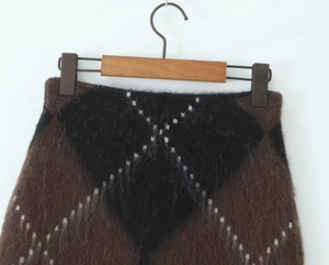 Detailed view of argyle mohair knit skirt with fluffy texture and warm brown pattern