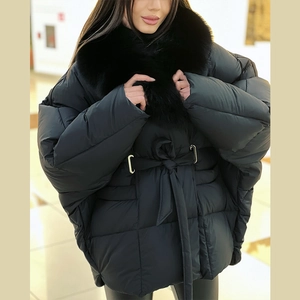Detail of black winter puffer coat with fluffy fur collar and waist drawstring tie