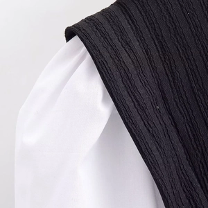 Fashionable black and white contrast top with puff sleeves and textured seersucker fabric