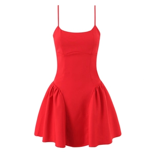 Detail of red sleeveless mini dress featuring pleated side ruching and corset waist
