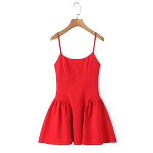 Detail of red sleeveless mini dress with pleated A-line skirt on a wooden hanger