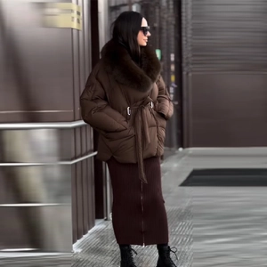 Close-up of dark brown padded coat with detachable faux fur collar and waist belt detail
