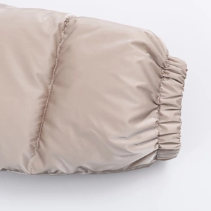 Close-up of windproof elastic cuffs on a khaki metallic puffer jacket with dense padding