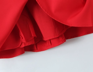 Detail of red dress hem with smooth plain weave fabric and professional stitched lining