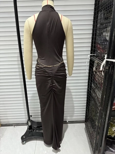 Detail of dark halter maxi dress featuring gold chain waist and ruched back design