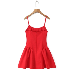Detail view of the back zipper and pleated waist on this red sleeveless mini dress