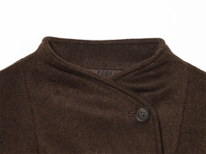 Detail of wool texture and asymmetric collar on dark brown winter jacket for women