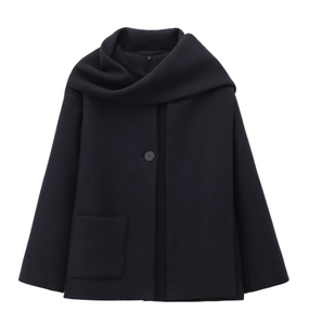 Detail of dark wool blend coat featuring a unique scarf collar and large utility pocket