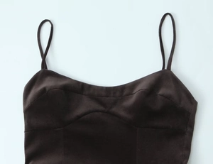 Close-up of slim straps and structured stitching on a dark brown slim-fit dress