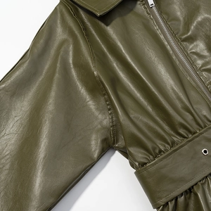 Detail of olive green faux leather jacket featuring metal zipper and belt eyelets