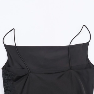 Detail of black satin top with delicate floral lace trim and thin shoulder straps