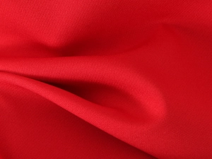 Detailed close-up showing the bright red woven fabric texture and pleated material finish