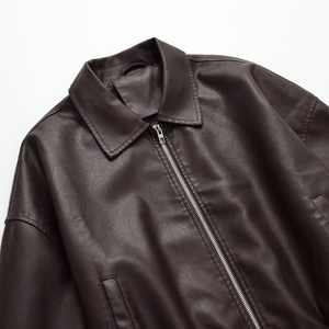 Detailed view of the lapel and metal zipper on this dark brown faux leather biker jacket