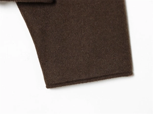 Close-up of the stitching and high-quality dark brown wool fabric on the sleeve cuff