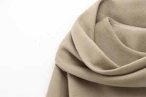 Close-up of premium camel wool blend fabric showing soft texture and thick material weave