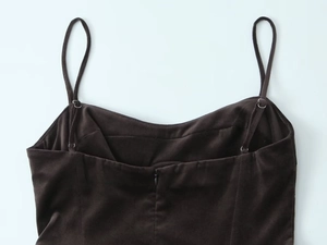 Detail of adjustable straps and invisible back zipper on a brown velvet dress