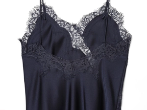 Detail of navy blue satin camisole showing delicate eyelash lace trim and silky texture