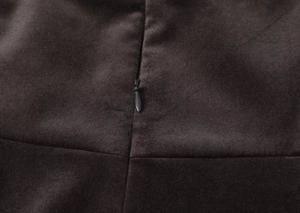 Macro shot of high-quality velvet fabric and matching invisible zipper on the dress