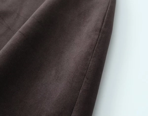 Detailed close-up showing the soft suede texture and rich brown fabric of the mini dress