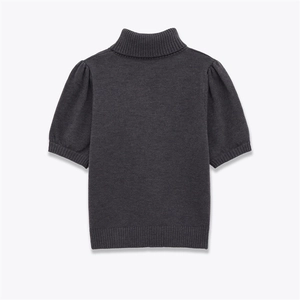 Macro detail of dark grey knit sweater featuring high ribbed neck and puff short sleeves