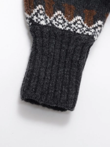 Women's loose knit sweater featuring ribbed cuffs and geometric jacquard patterns
