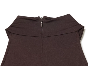 Detail of invisible zipper on halter neck dress with ribbed knit texture in dark brown