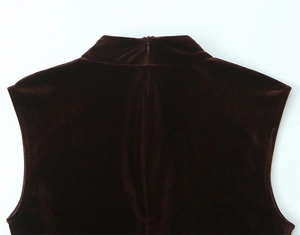Detail of dark brown velvet mini dress featuring mock neck and invisible back zipper